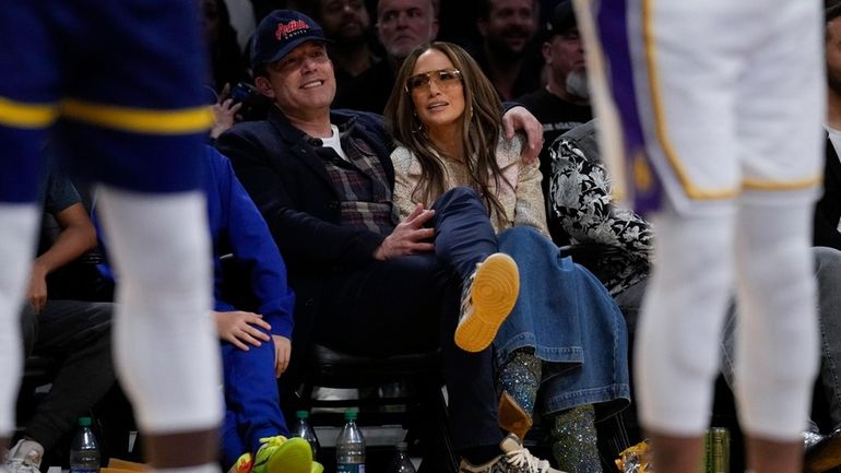 Ben Affleck and Jennifer Lopez watch an NBA basketball game...