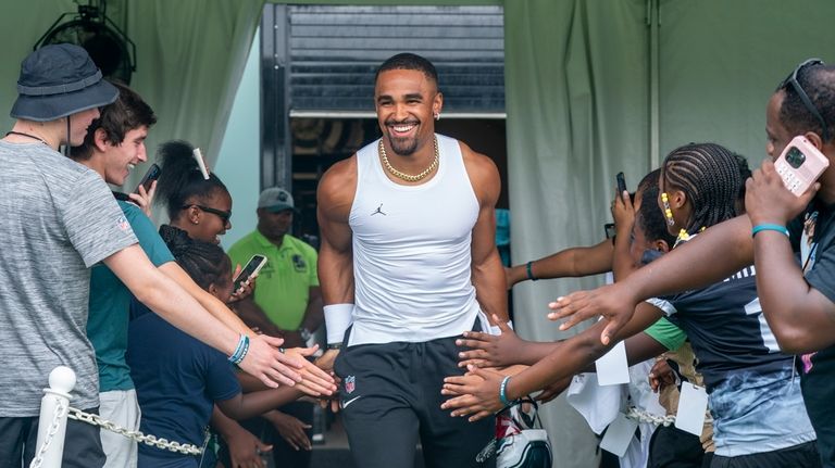 Philadelphia Eagles quarterback Jalen Hurts heads out to the field...