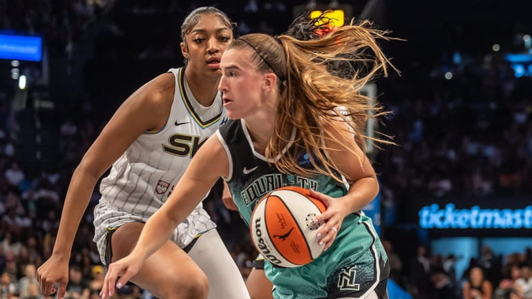 The Liberty’s Sabrina Ionescu drives against Angel Reese of the...