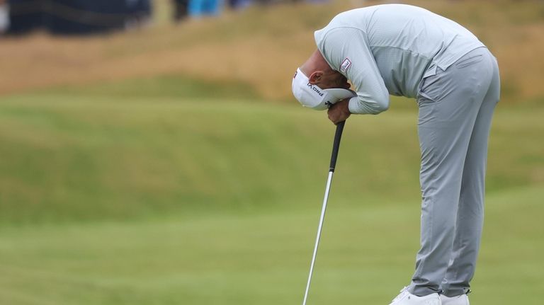 Michael Hendry of New Zealand reacts on the 13th green...