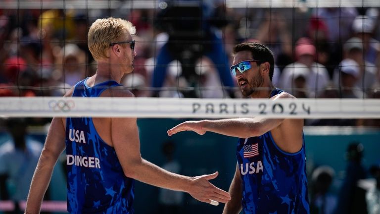 US' Chase Budinger and Miles Evans react during the men's...