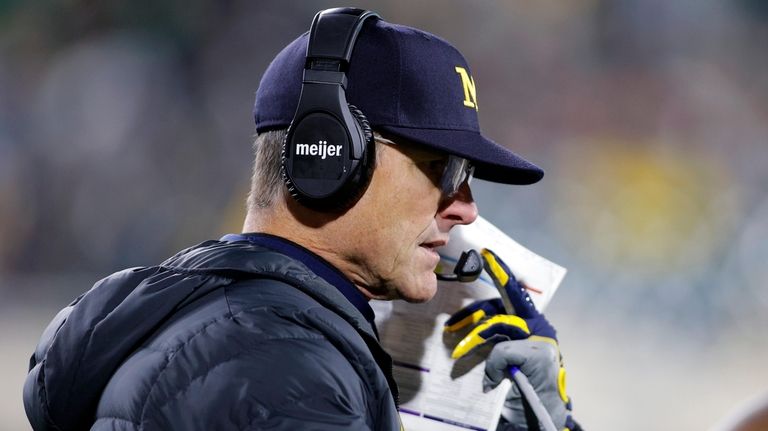 Michigan coach Jim Harbaugh looks on during the second half...