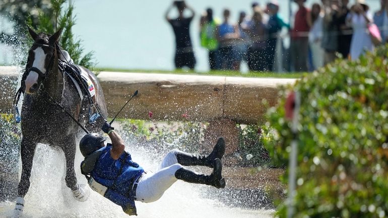 Ecuador's Ronald Zabala G., riding, Forever Young Wundermaske, fall off...