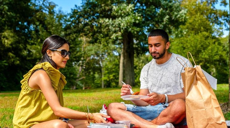 Melanie Gangapersaud and Andrew Singh have a picnic on the lawn...