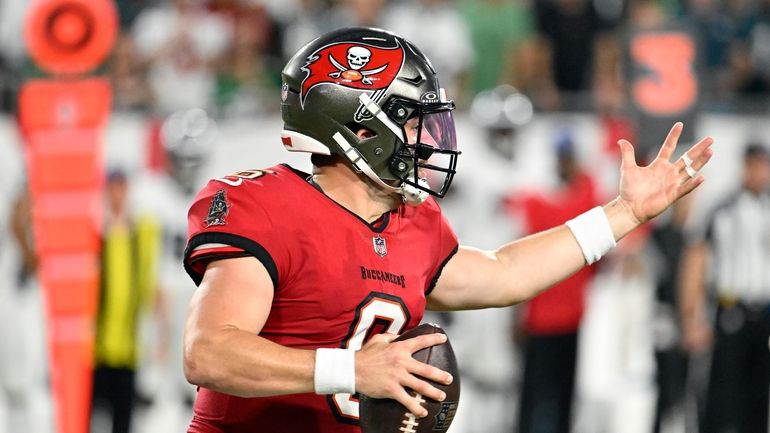 Tampa Bay Buccaneers' Baker Mayfield rolls out during the first...