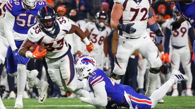 Buffalo Bills' Von Miller, bottom right, tackles Denver Broncos' Javonte...