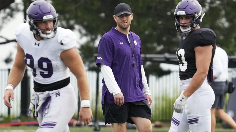 Northwestern interim head coach David Braun, center, watches players during...