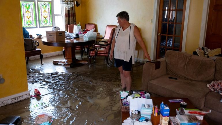 Ann Farkas walks in her flood-damaged home in Canisteo, N.Y.,...