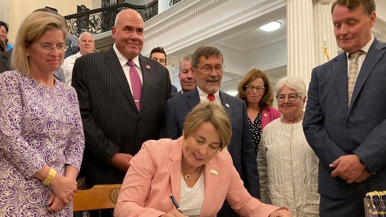 Massachusetts Gov. Maura Healey signs into law a bill that...