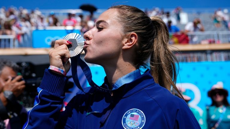 Nevin Harrison, of the United States, celebrates with the silver...