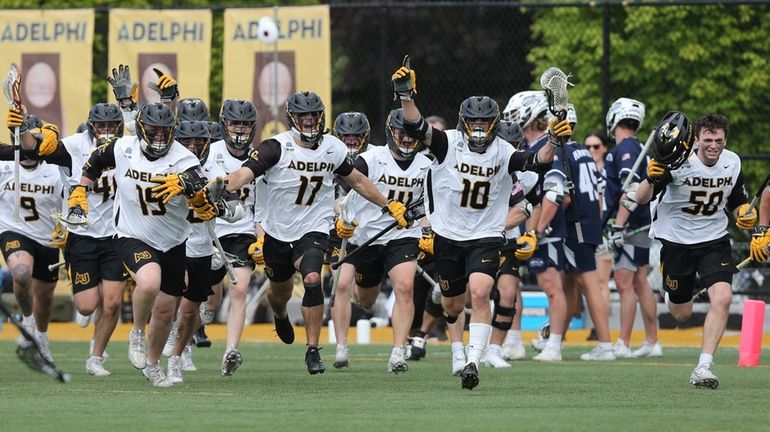 Adelphi celebrates its win over St. Anselm a NCAA Division II men's...