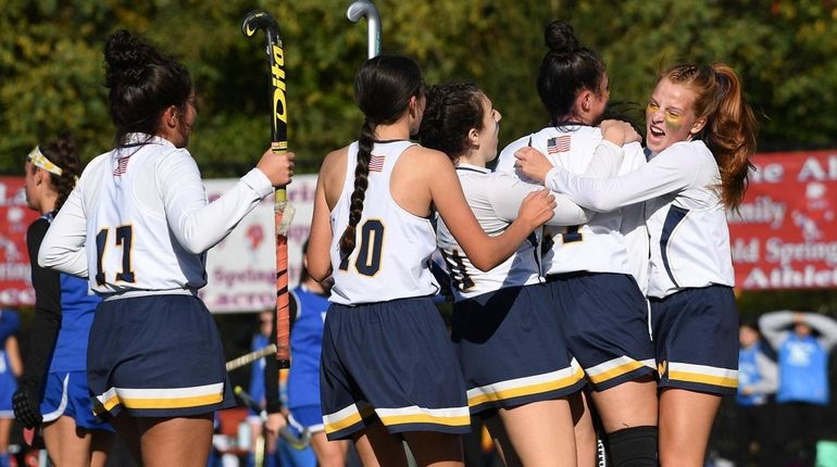 Massapequa players congratulate Nicolette Buffolino after she scored a goal...