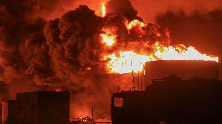 Oil tanks burn at the port in Hodeidah, Yemen, Saturday,...