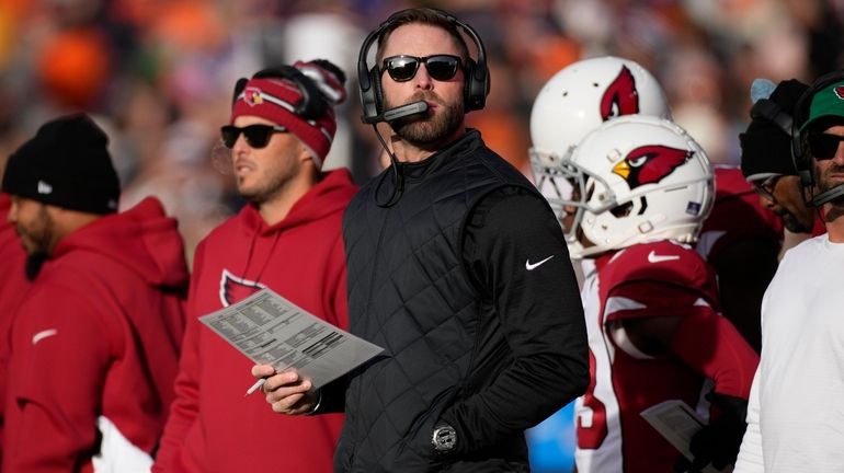 Arizona Cardinals head coach Kliff Kingsbury looks towards the scoreboard...