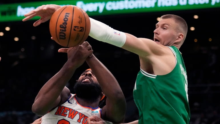Celtics center Kristaps Porzingis, right, blocks a shot by Knicks...
