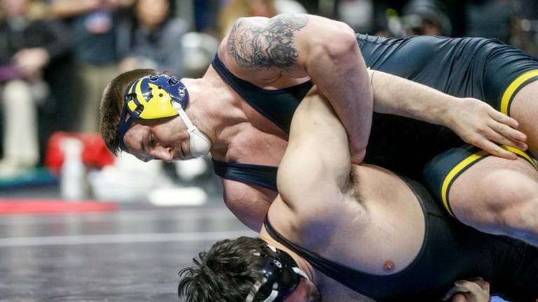 Michigan's Mason Parris attempts to turn Iowa's Tony Cassioppi during...