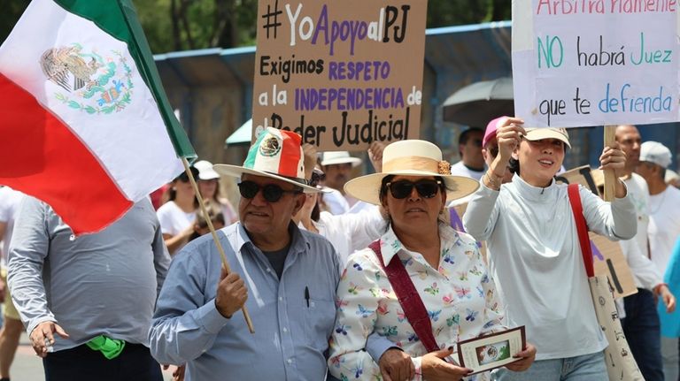 Federal court workers gather as they strike over reforms that...