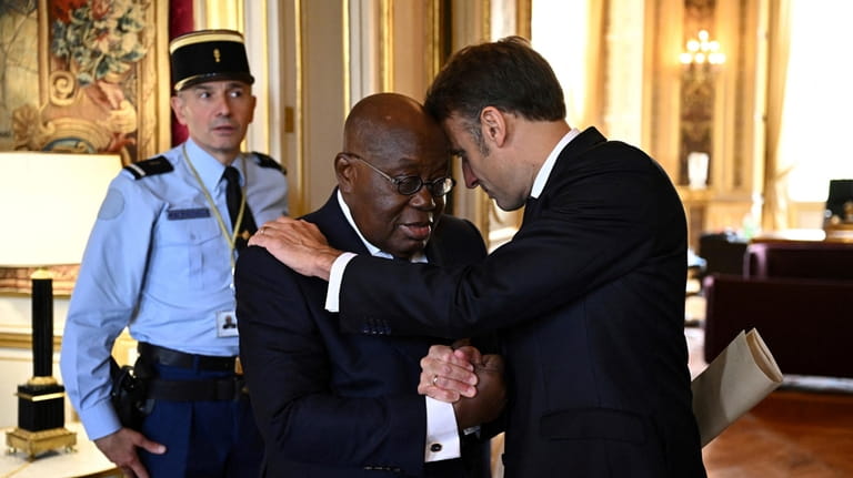 French President Emmanuel Macron greets Ghana's President Nana Akufo-Addo after...