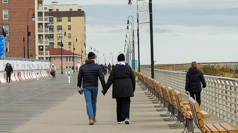 Strollers on the Long Beach boardwalk Sunday.