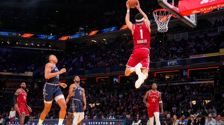 Phoenix Suns guard Devin Booker (1) goes up for a...