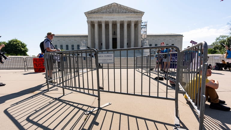 Activists wait as the Supreme Court announces decisions, on Capitol...