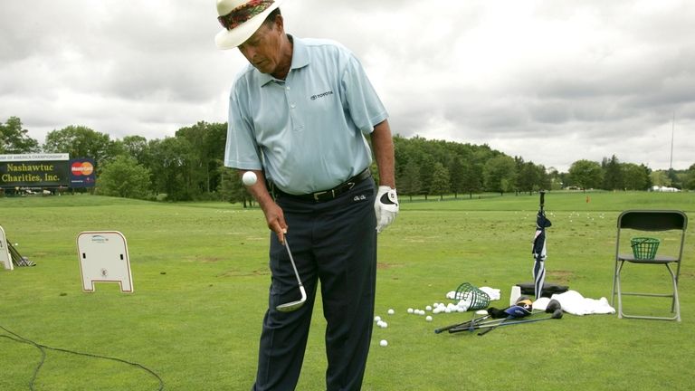 Golfer Chi Chi Rodriguez bounces a golf ball on the...