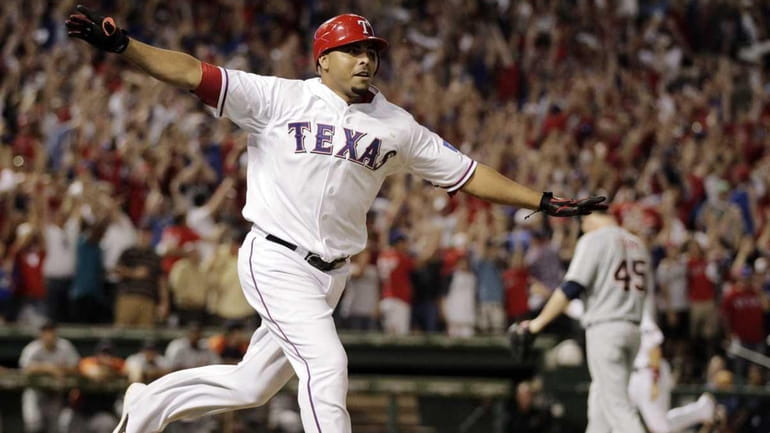 Texas Rangers' Nelson Cruz reacts after hitting a grand slam...