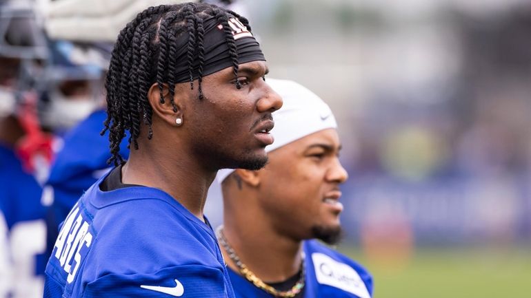 Giants wide receiver Malik Nabers, left, stands with wide receiver...