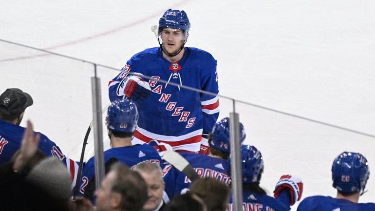 Rangers defenseman Adam Fox celebrates his goal with teammates in...