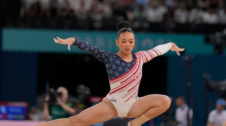 Suni Lee, of the United States, performs on the floor...