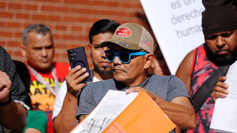 Resident Moises Didenot shows his receipts that he paid rent...