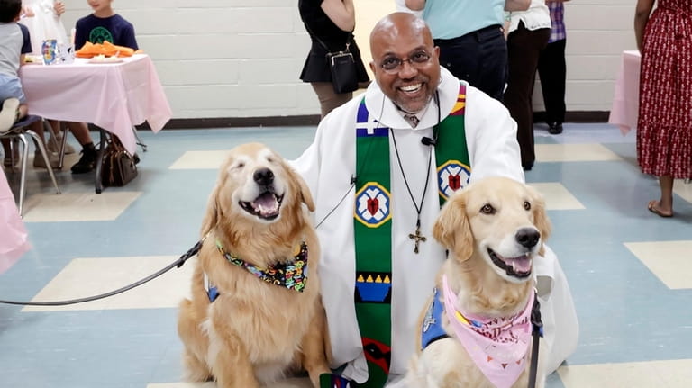 The Rev. Johnson E. Rethinasamy poses with the dogs at...