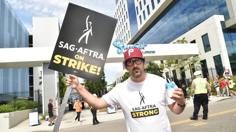 Adam Shapiro poses on a picket line outside Netflix studios...