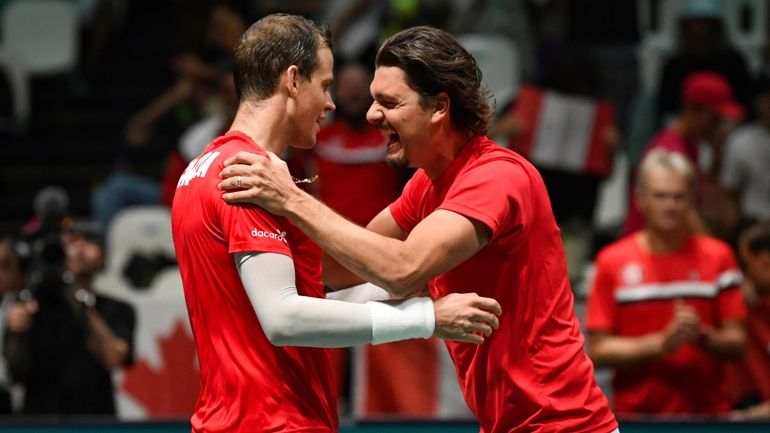 Canada's Frank Dancevic, right, congratulates Canada's Vasek Pospisil after he...