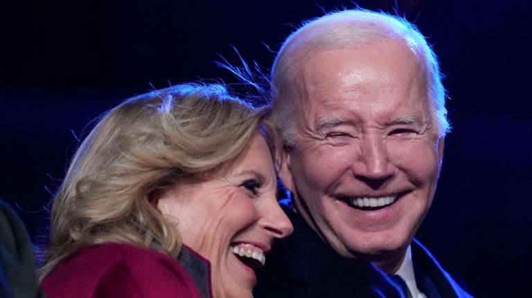 President Joe Biden and first lady Jill Biden listen to...