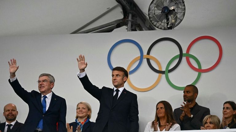 France's President Emmanuel Macron, center, and IOC President Thomas Bach,...