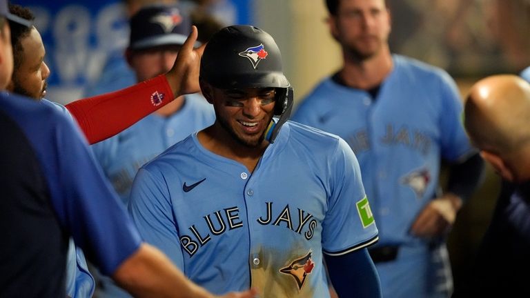 Toronto Blue Jays' Leo Jimenez celebrates scoring off a single...