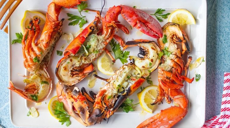 Lobsters are boiled, split, grilled until lightly charred and topped...