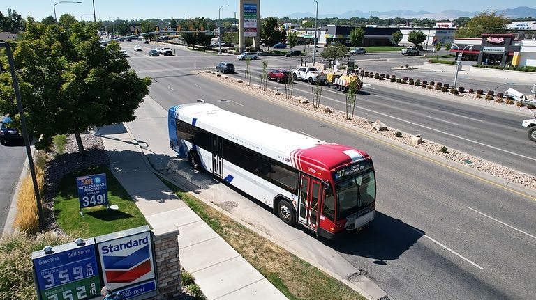 A commuter bus equipped with a radio transmitter passes a...