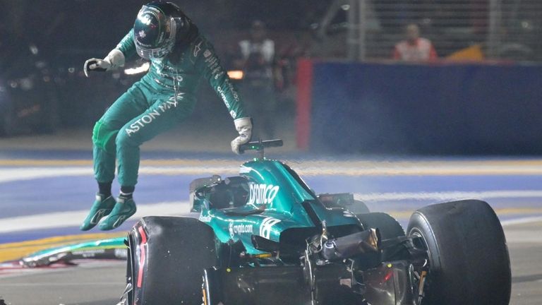 Aston Martin driver Lance Stroll of Canada jumps out from...