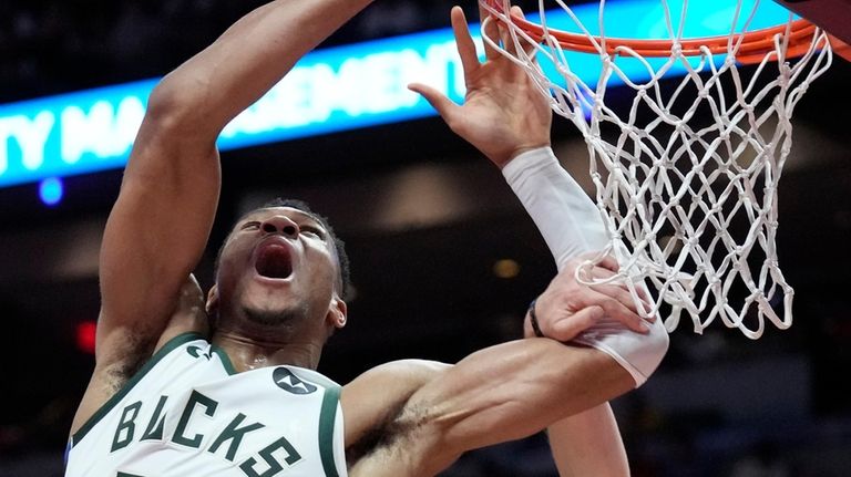 Milwaukee Bucks forward Giannis Antetokounmpo (34) goes up for a...