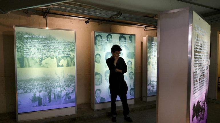 A visitor looks at an exhibit during the inauguration of...