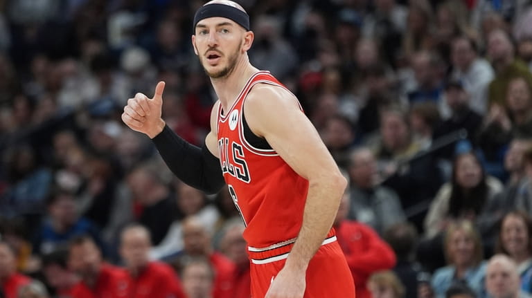 Chicago Bulls guard Alex Caruso gestures after making a 3-point...