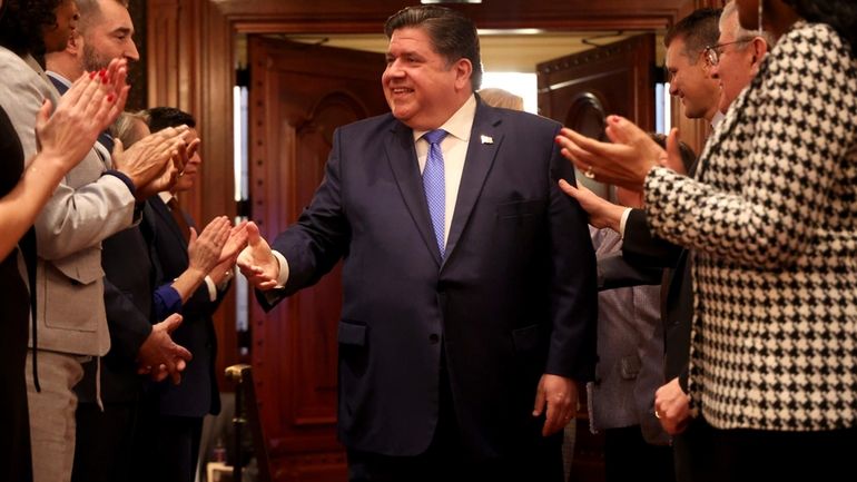 Illinois Gov. J.B. Pritzker arrives to deliver his State of...