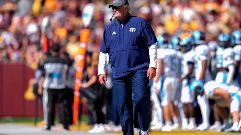 Rhode Island head coach Jim Fleming stands on the sideline...