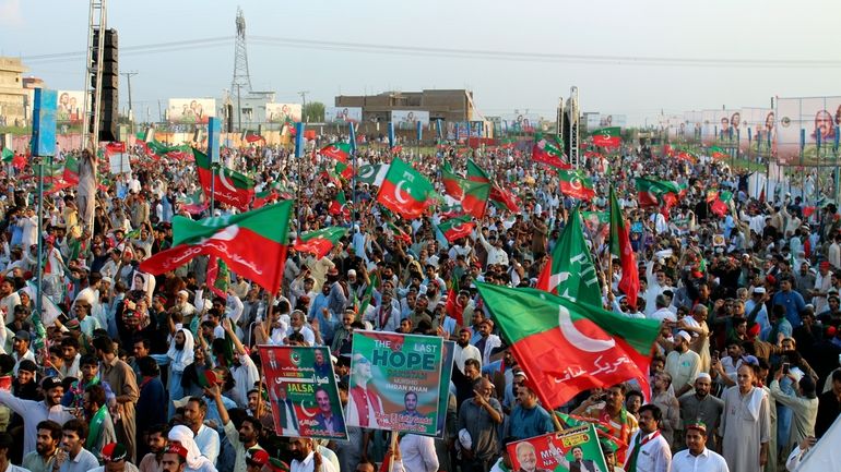 Supporters of imprisoned former Prime Minister Imran Khan take a...