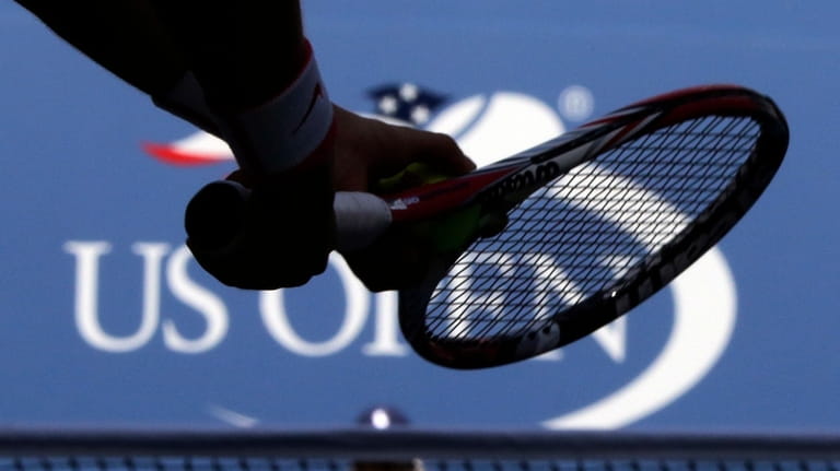 A player prepares to serve during the U.S. Open tennis...