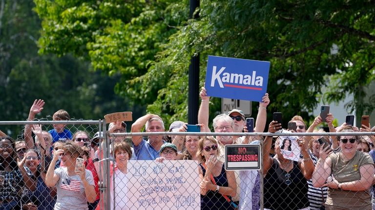 Supports hold signs before Vice President Kamala Harris arrives to...