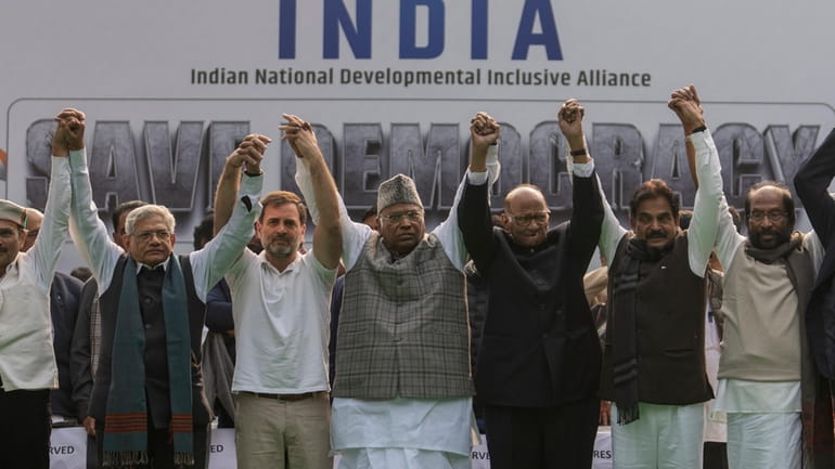 FILE- Leaders from the opposition INDIA alliance raise their hands...