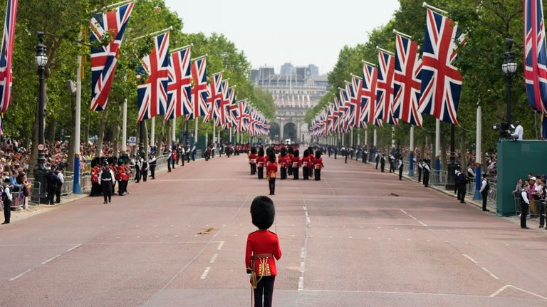 Troops marching down the Mall to Horse Guards parade to...